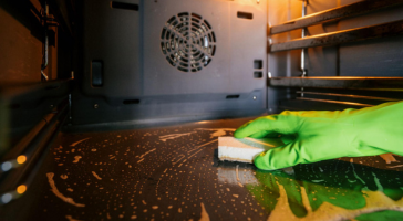 Professional storefront and office building exterior cleaning with technicians working on sidewalks and building surfaces in a polished business environment